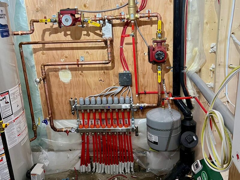 Residential boiler and hydronic in-floor heating manifold with tekmar controls installed in Cranston, SE Calgary