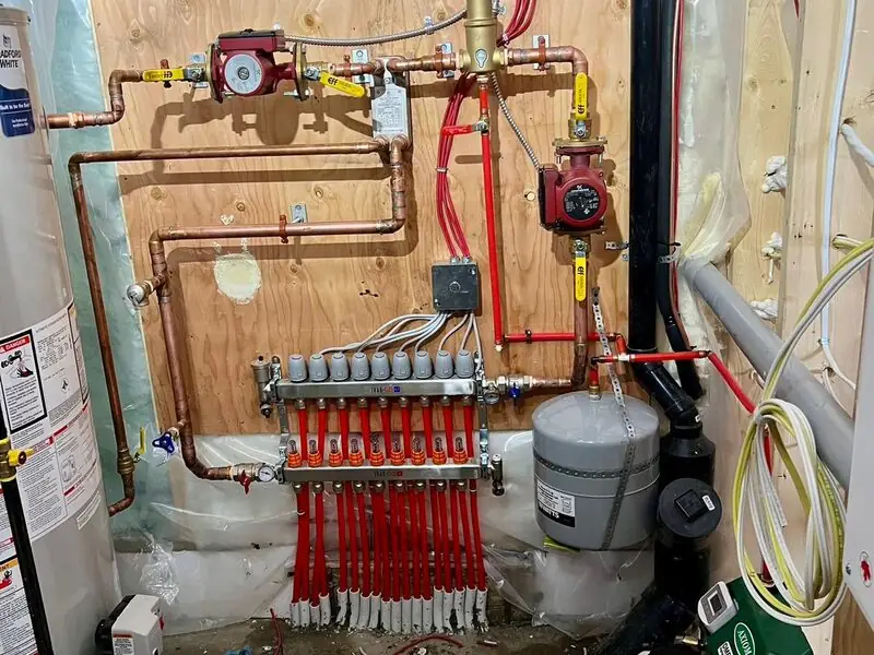 Residential boiler and hydronic in-floor heating manifold with tekmar controls installed in Cranston, SE Calgary