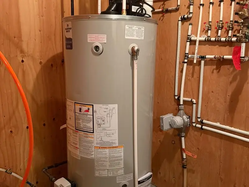 Bradford White power-vent hot water tank with PEX manifold plumbing installed in Kincora, NW Calgary