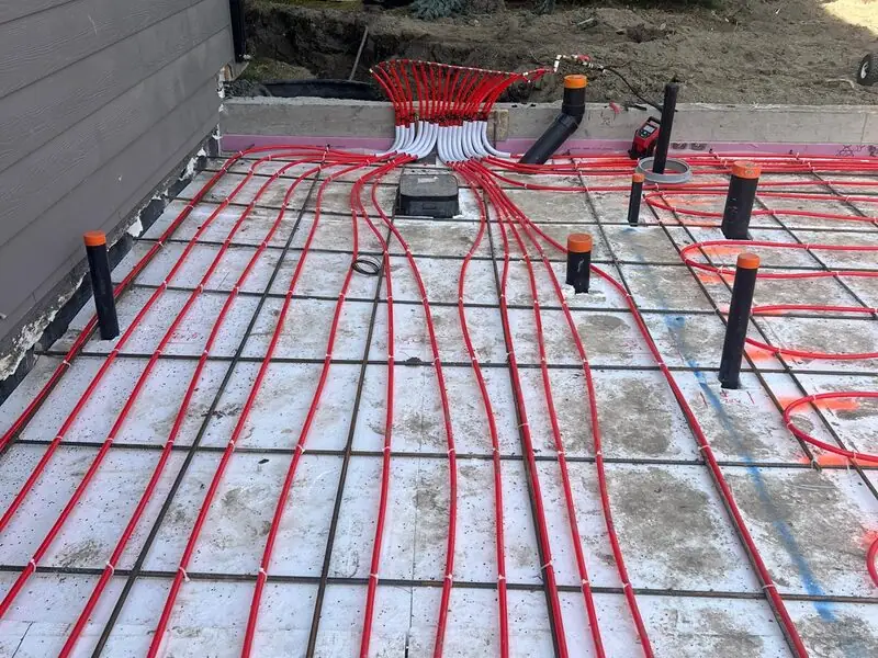 In-floor radiant heating PEX tubing laid over a reinforced slab in Mount Douglas, SE Calgary